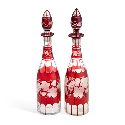 Lot 101 - A NEAR PAIR OF RUBY GLASS DECANTERS AND STOPPERS