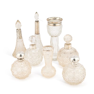 Lot 317 - A COLLECTION OF VICTORIAN AND LATER SILVER MOUNTED CUT-GLASS SCENT BOTTLES AND VASES