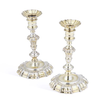 Lot 666 - A PAIR OF GEORGE II CAST SILVER-GILT CANDLESTICKS