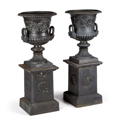 Lot 1127 - A LARGE PAIR OF CAST IRON URNS ON STANDS