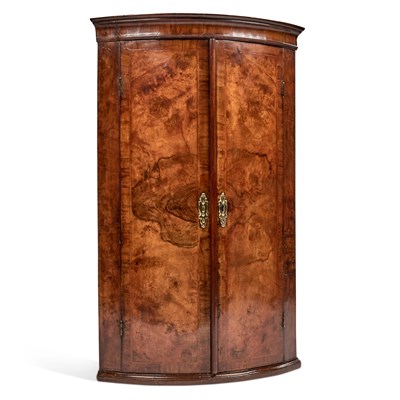 Lot 1078 - AN EARLY 18TH CENTURY WALNUT BOW-FRONT HANGING CORNER CUPBOARD