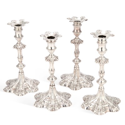 Lot 423 - A SET OF FOUR EARLY GEORGE III CAST SILVER CANDLESTICKS