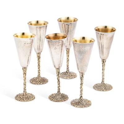 Lot 307 - A SET OF SIX ELIZABETH II PARCEL-GILT SILVER CHAMPAGNE FLUTES