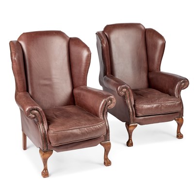 Lot 1019 - A PAIR OF BROWN LEATHER UPHOLSTERED WING-BACK ARMCHAIRS