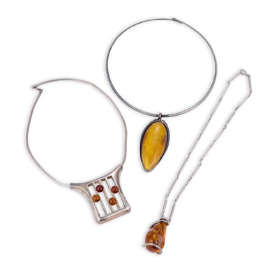 Lot 684 - THREE SILVER AND AMBER PENDANT NECKLACES