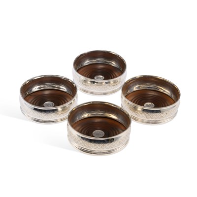 Lot 430 - A SET OF FOUR GEORGE III SILVER TABLE WINE COASTERS
