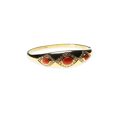 Lot 642 - A CORAL AND DIAMOND HINGE OPENING BANGLE