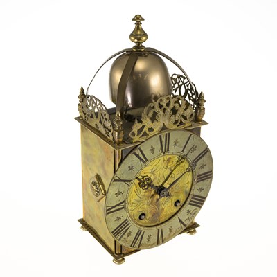 Lot 1048 - A BRASS LANTERN CLOCK