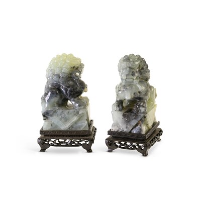 Lot 512 - A PAIR OF CARVED HARDSTONE LION DOGS