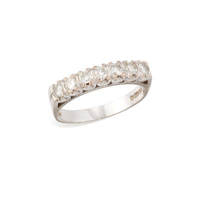 Lot 509 - AN 18 CARAT WHITE GOLD DIAMOND HALF HOOP RING