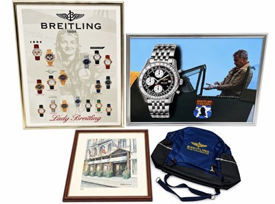 Lot 454 - A BREITLING RUCKSACK, TWO BREITLING FRAMED PRINTS AND A CARTIER FRAMED PRINT