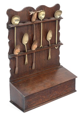 Lot 873 - AN OAK SPOON RACK AND A COLLECTION OF BRASS SPOONS