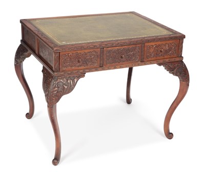 Lot 876 - A CARVED HARDWOOD WRITING TABLE
