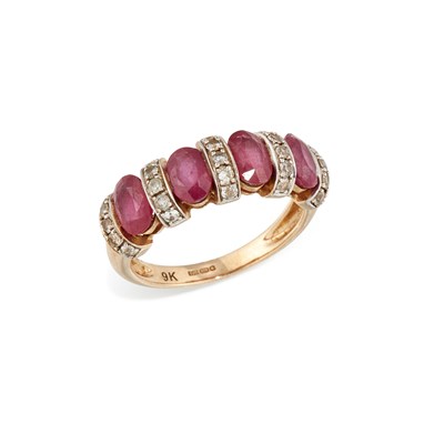 Lot 634 - A 9 CARAT GOLD RUBY AND WHITE STONE RING