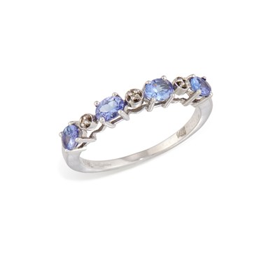 Lot 631 - A 14 CARAT WHITE GOLD TANZANITE AND DIAMOND HALF HOOP RING