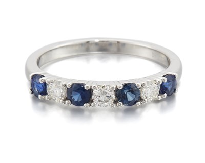Lot 2022 - A PLATINUM SAPPHIRE AND DIAMOND HALF HOOP RING